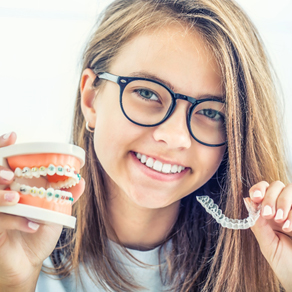 young person holding Invisalign aligners 