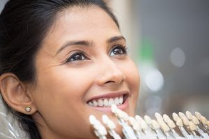 a woman trying porcelain veneers